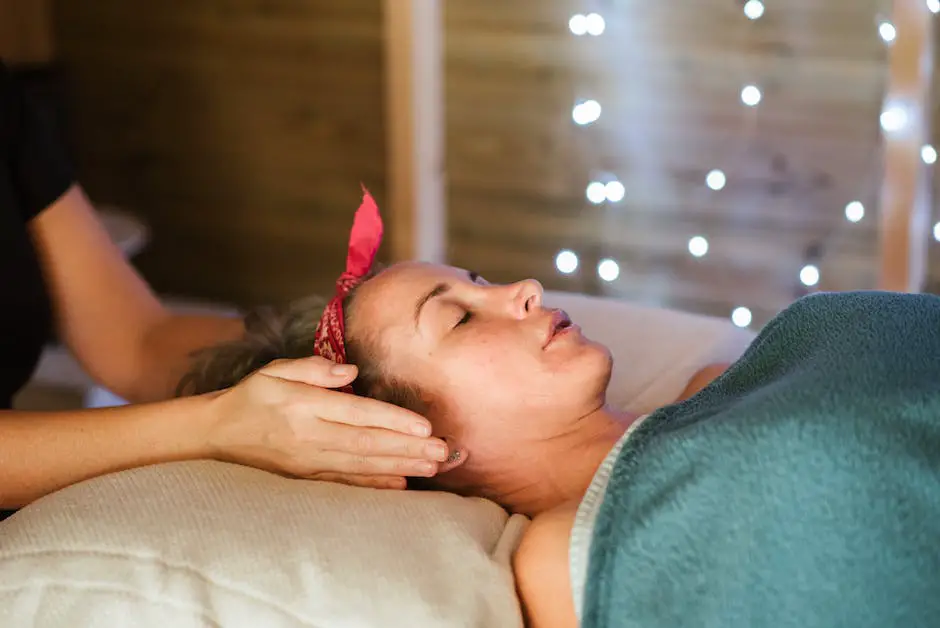 Image of hands held above a person's body during a Reiki session